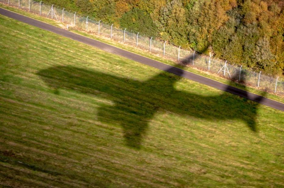 The shadow of a commercial jet as it comes in to land at Edinburgh Airport, Scotland.